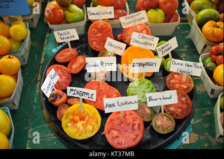 Sliced arrangement of colorful heirloom tomato types on display at Royal Oak Farmers' Market, Royal Oak, Michigan, USA. Stock Photo