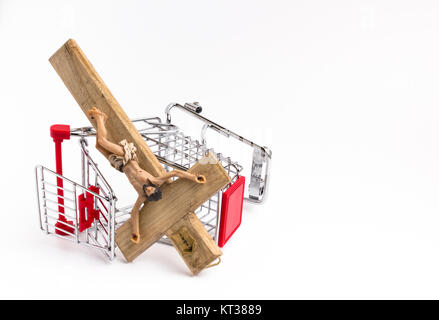 Shopping cart overturned with crucifix on the ground Stock Photo