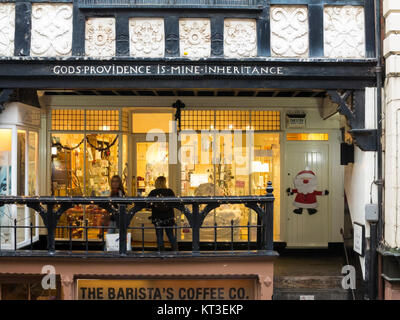 Two women Christmas  shopping  looking in shop windows in the Roman city of Chester England Stock Photo