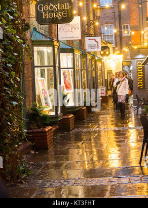 View along the wet pavements of the medieval godstall lane that links the city centre with the cathedral in the roman city of Chester Cheshire England Stock Photo