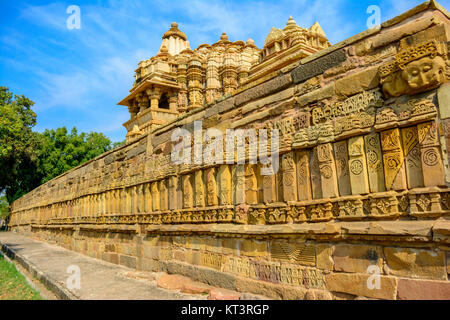 Close up of side wall Chitragupta Hindu temple against blue sky - Khajuraho Madhya Pradesh, India Stock Photo
