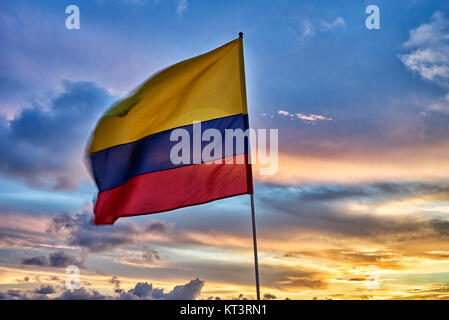 waving Colombian flag again sunset sky Stock Photo
