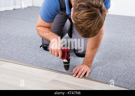 Carpenter Using Wireless Screwdriver Stock Photo