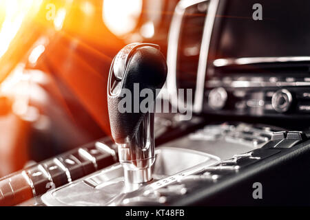 Close-up on automatic transmission lever in modern car. multimedia and navigation control buttons. Car interior details. Transmission shift. Stock Photo