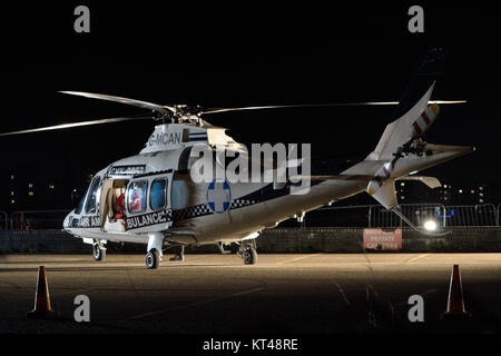Helicopter being used as a prop on a film set during a night time film shoot taking place on Albert Island in London's Royal Docks in England, UK Stock Photo