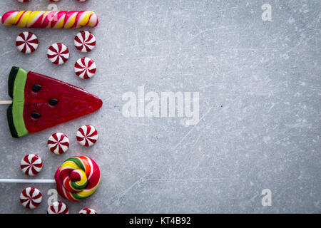 Colorful candies on stone background. Top view with copy space Stock Photo