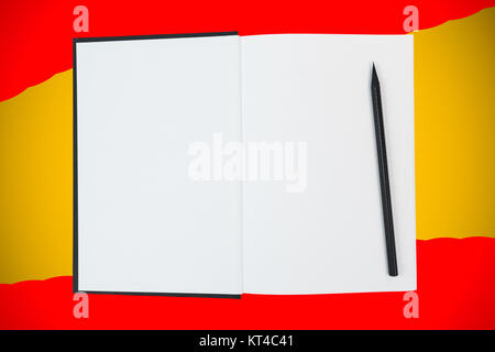 Open book with blank white pages and black wooden pencil on yellow and red background Stock Photo