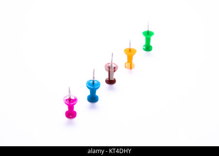 colorful needles in a row on white Stock Photo