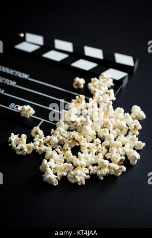 Clapperboard and popcorn. Stock Photo