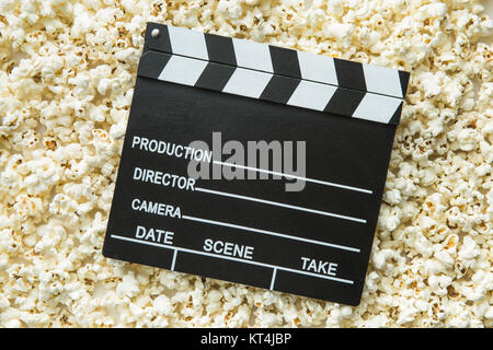 Clapperboard and popcorn. Stock Photo