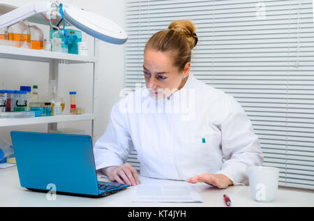 Experienced scientist works with portable computer in research laboratory Stock Photo