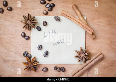 With love note and spices on wooden background. Stock Photo