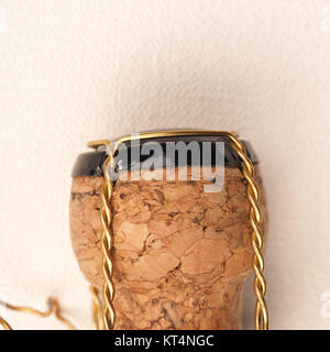 Champagne bottle cork on a white fabric, close up shot Stock Photo