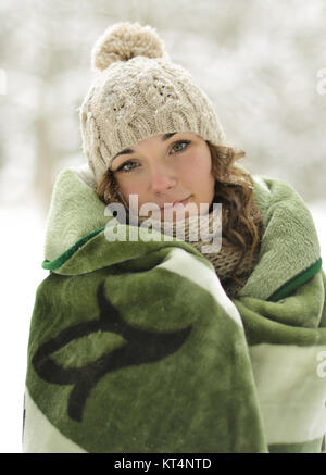 Very lovely,beautiful,cute,cheerful,smiling,adorable,excellent,awesome,nice,attractive,wonderful girl with warm,green plaid,blanket,wrapped up warm plaid,blanket.Creative winter portrait of the girl,model in cold,frosty winter. Stock Photo