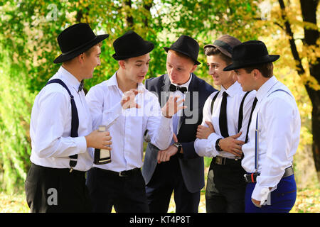 True really friends speak about something and demonstrate. Group of men talking outdoors in good weather. Men's Group communication. Cheerful old friends having fun Stock Photo