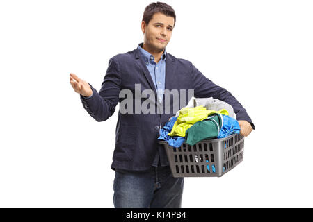 Unhappy elegant guy holding a laundry basket filled with clothes isolated on white background Stock Photo