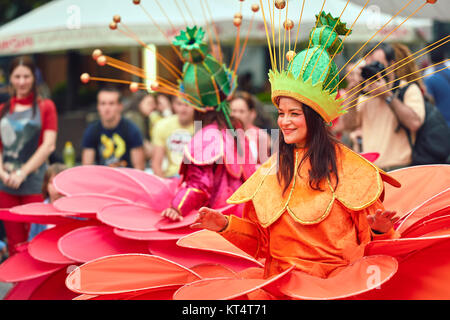 Bucharest, Romania - May 29, 2014: Female dancers in large exotic colorful costumes present The Giant Flowers show during the B-Fit International Stre Stock Photo