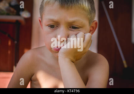 A young boy looking sad.