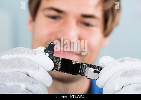 Man Holding Smart Phone Circuit Board Stock Photo