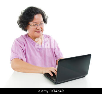 Senior adult woman using laptop computer Stock Photo