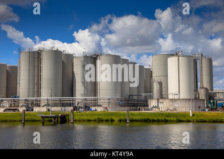 Tank Storage area with docking facility in industrial harbor in the Netherlands Stock Photo