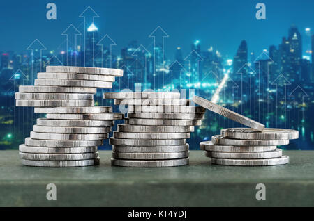 Coin stacks with finance growth up and cityscape background. Stock Photo