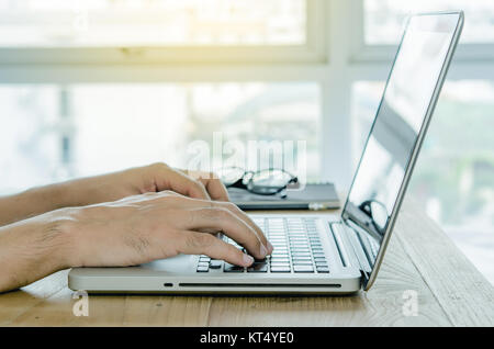 Close-up man hand using computer laptop in office. Stock Photo