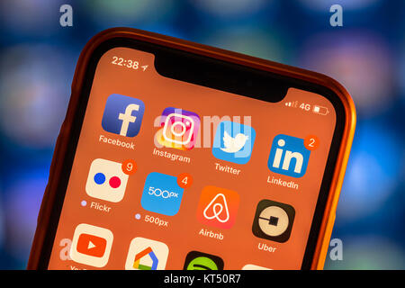 NEW YORK, USA - NOVEMBER 7, 2017: Social media app icons on modern new smartphone display close-up around other iphone applications Stock Photo
