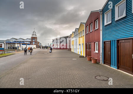 HELGOLAND, GERMANY - DECEMBER 18, 2016: Colorful buildings in the Harbor of Helgoland island on a cloudy day, Germany Stock Photo