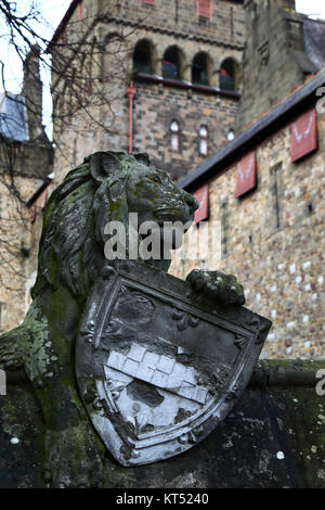 Stone sculpture of lion with shield on Animal Wall, Cardiff Castle in background, Cardiff, South Glamorgan, Wales, United Kingdom Stock Photo