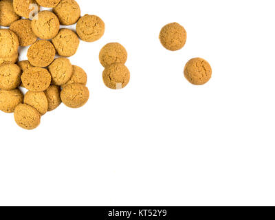 Bunch of Scattered Pepernoten cookies as Sinterklaas decoration on white background for dutch sinterklaasfeest holiday event on december 5th Stock Photo