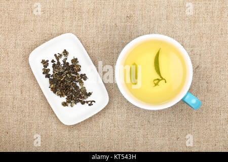 Cup of green tea on canvas tablecloth Stock Photo