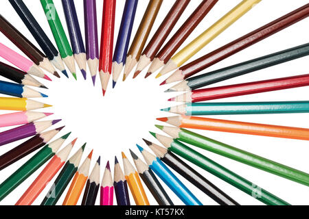 Set of colored pencils lined up in a circle in the shape of a heart isolated on a white background Stock Photo