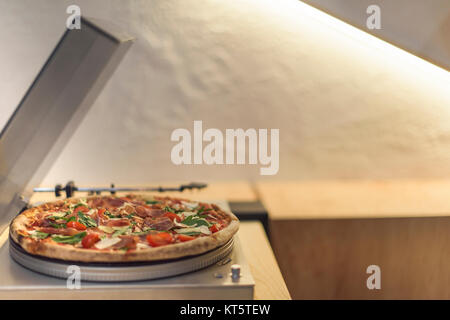selective focus of pizza on vintage vinyl record player Stock Photo