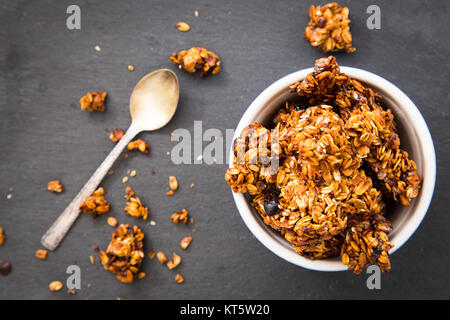 Healthy breakfast. Fresh granola, muesli in a glass jar. copy space.Organic oat,almond and cherry Stock Photo