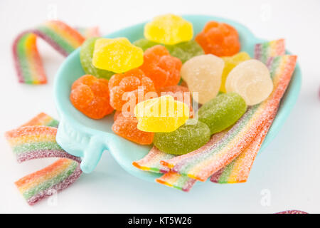 Candy background. Colorful candies in plate on light background Stock Photo