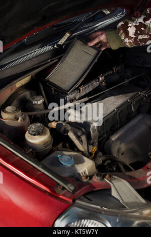 the mechanic pulls out the old air filter. Stock Photo