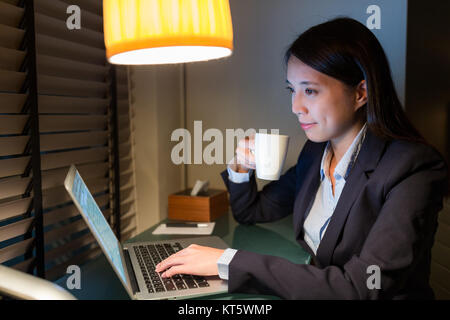 Businesswoman working over night Stock Photo