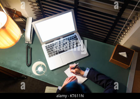 Top view of businesswoman taking note on the desk Stock Photo