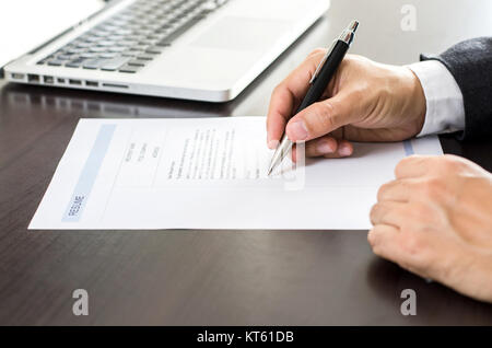 Close-up man signing of on resume form. Stock Photo