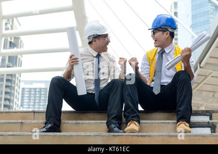 Two asian architects keeping hands up with happy moment. Stock Photo