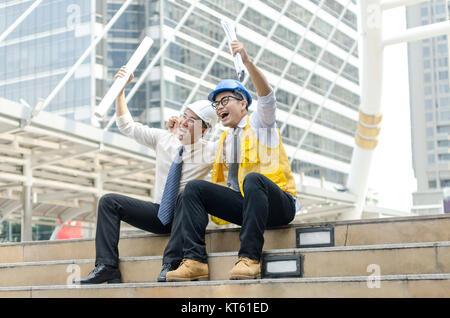 Success business concept. Two asian architects hands up with happy moment. . Stock Photo