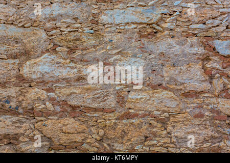 Old adobe rock wall texture background close Stock Photo
