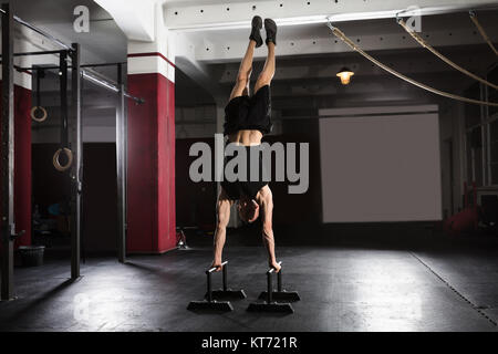 Man Doing Handstand On Parallel Bar Stock Photo
