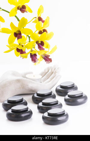 Spa concept with hot stones and tea light close up Stock Photo
