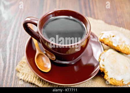 Coffee in brown cup with cookies on dark board Stock Photo