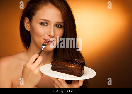 chocolate cake - glamorous woman eats dessert Stock Photo