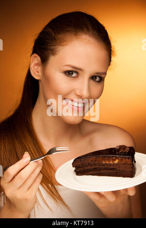 chocolate cake - glamorous woman eats dessert Stock Photo