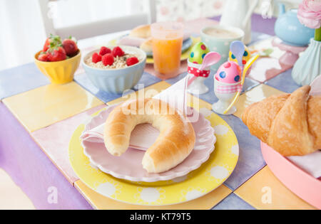 Bunter Tisch gedeckt fuer ein Oster Fruehstueck Stock Photo