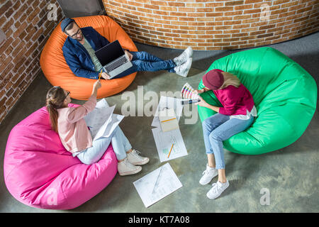 People in bean bag chairs Stock Photo